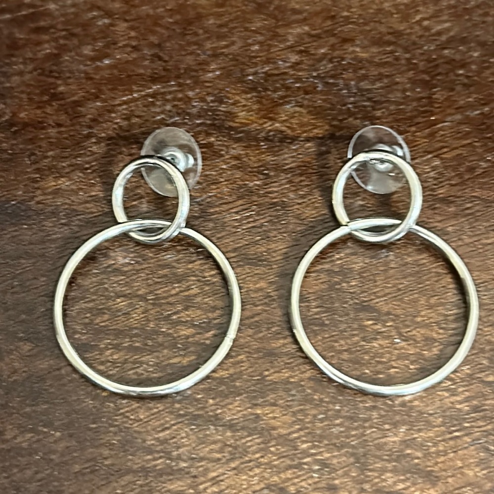 Woman’s beautiful, two circle fake silver earrings